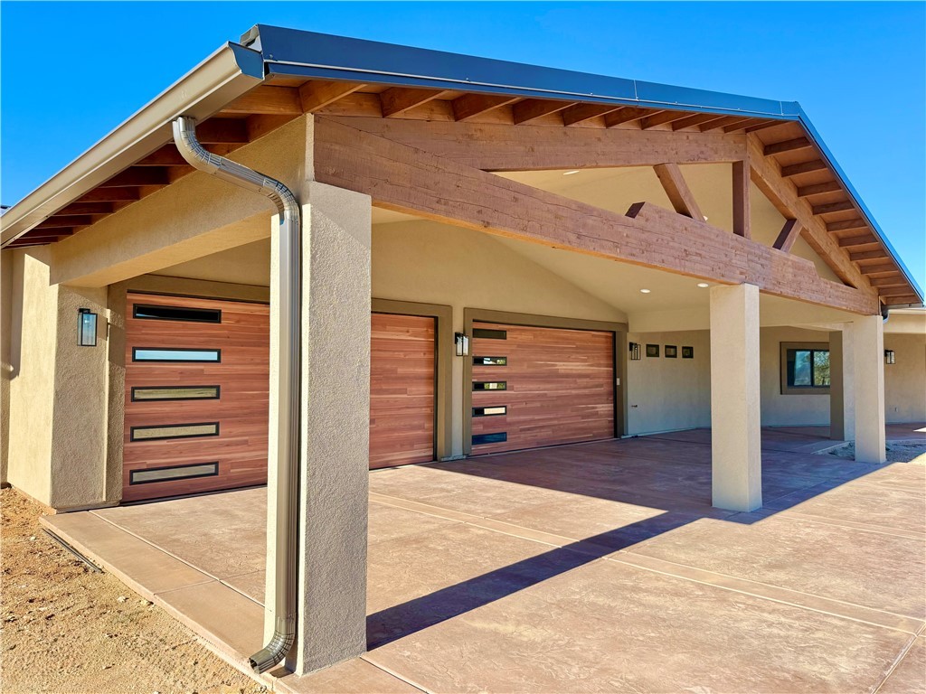 919 West Jordan Ranch Road Kingman, AZ 86409 - Photo 2 of 53 Modern wood look garage doors and gorgeous timber frame gable add a luxury presence.