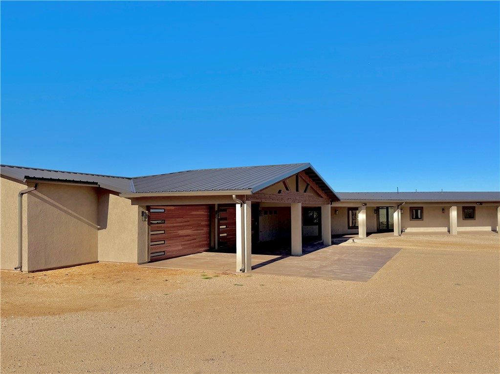 919 West Jordan Ranch Road Kingman, AZ 86409 - Photo 6 of 53 Covered patio and garage approach showcase the amazing lines and architectural details!
