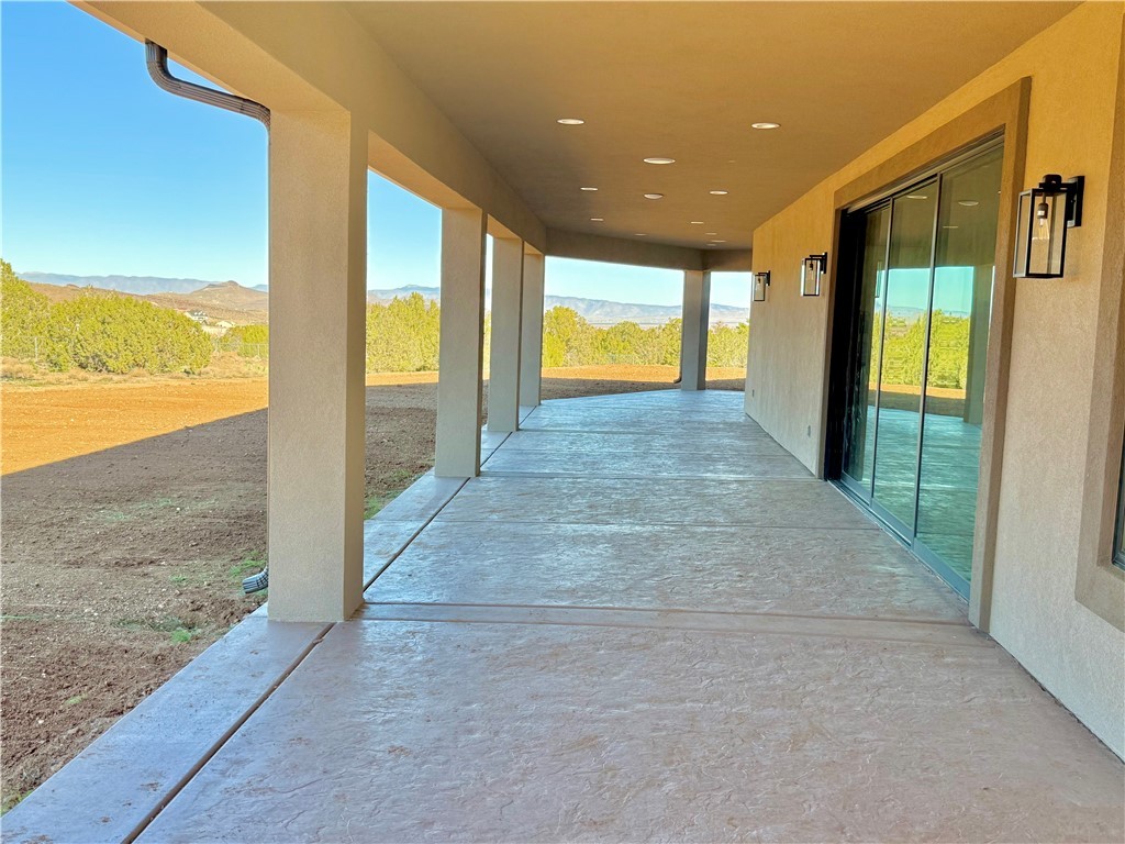 919 West Jordan Ranch Road Kingman, AZ 86409 - Photo 8 of 53 Oversized covered patio has custom styled lighting and a 3 tiered sliding glass door.