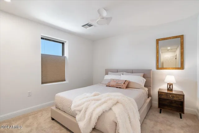 a bedroom with a bed and a lamp