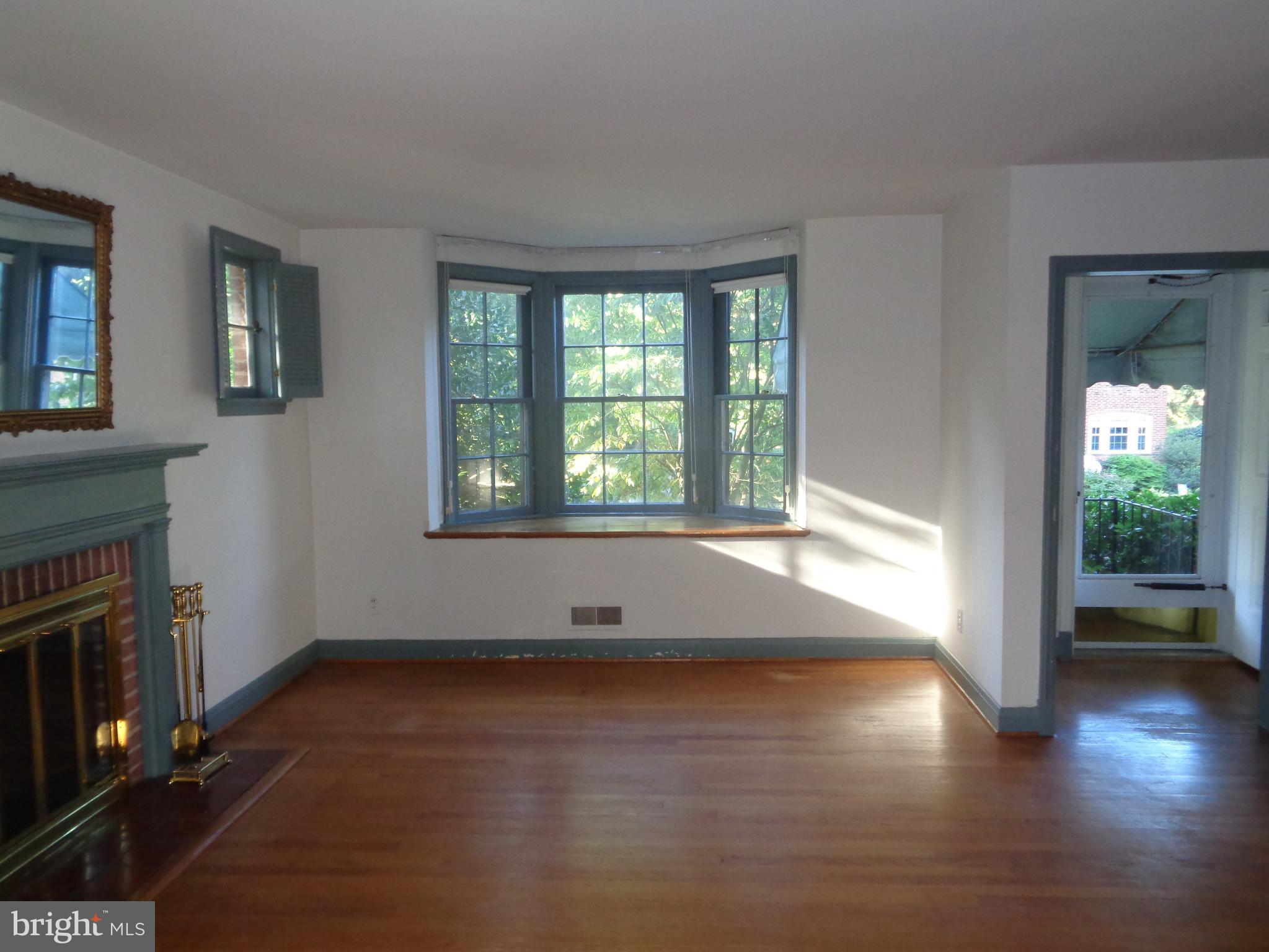 248 Gaywood Road Baltimore, MD 21212 - Photo 3 of 25 an empty room with wooden floor and windows