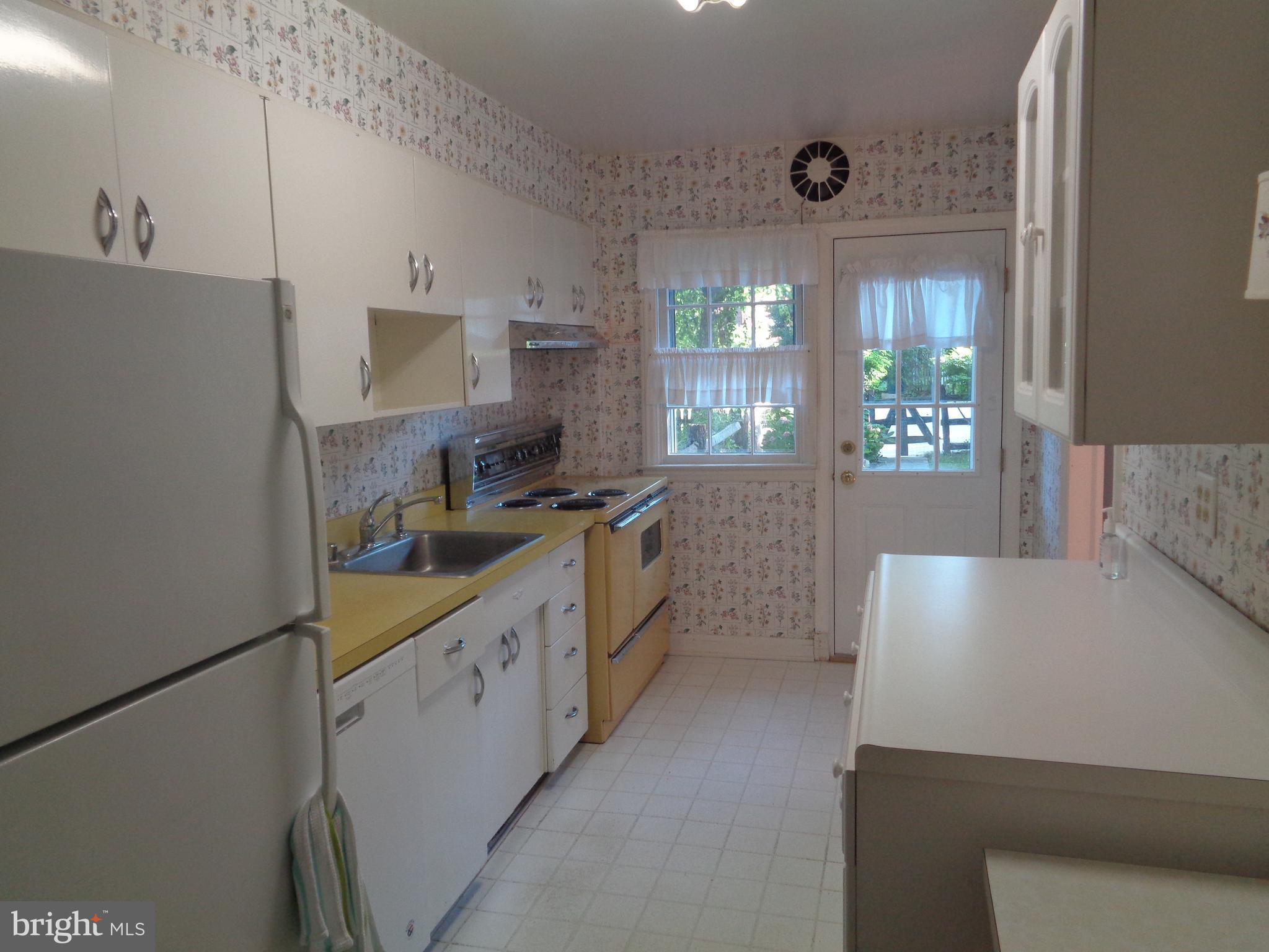 248 Gaywood Road Baltimore, MD 21212 - Photo 8 of 25 a kitchen with white cabinets and a stove