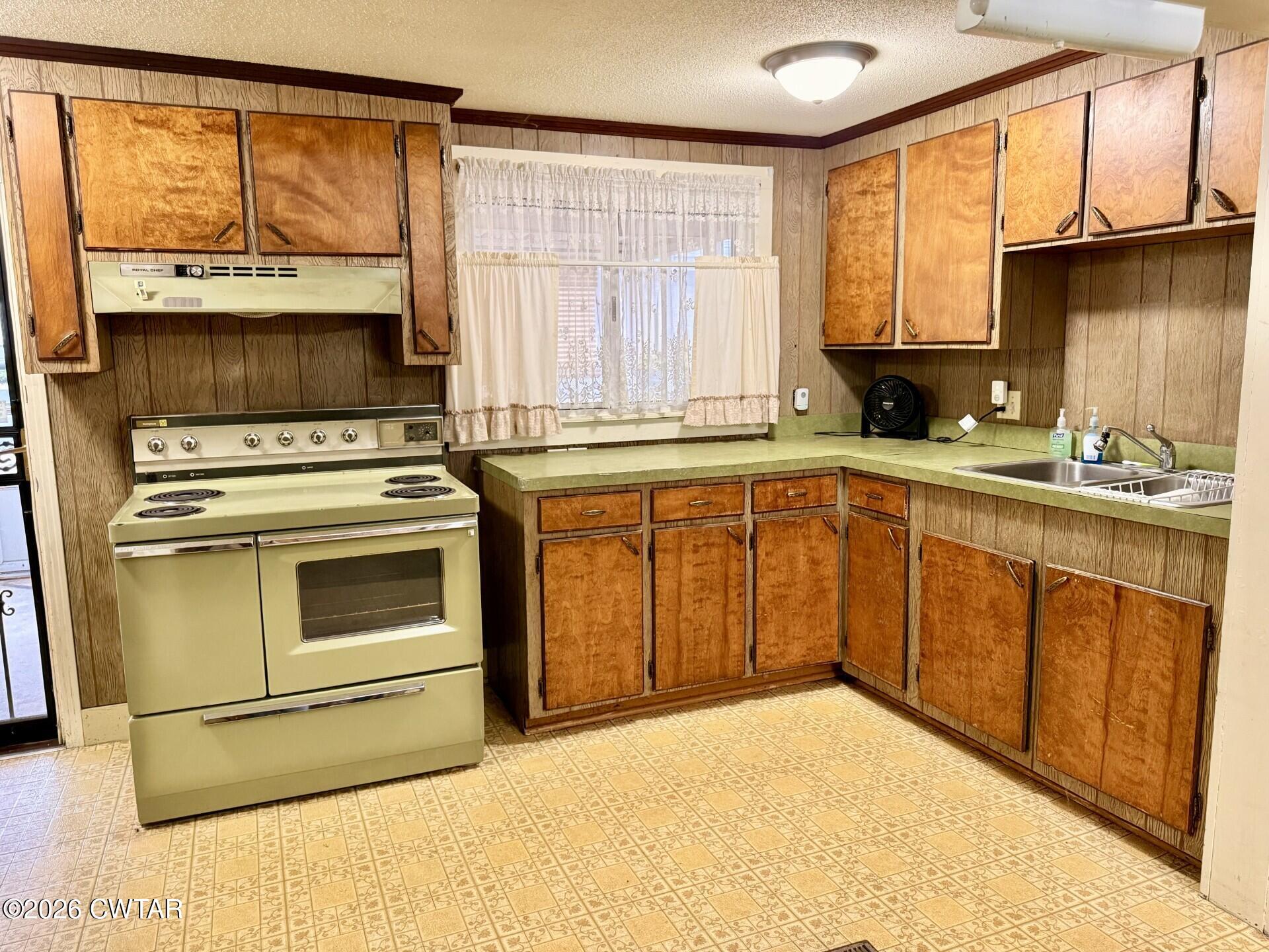 406 Maple Heights Street Kenton, TN 38233 - Photo 16 of 43 a kitchen with a stove a sink and a window
