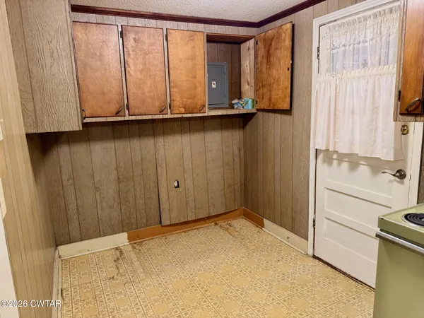a view of an empty room with a fireplace