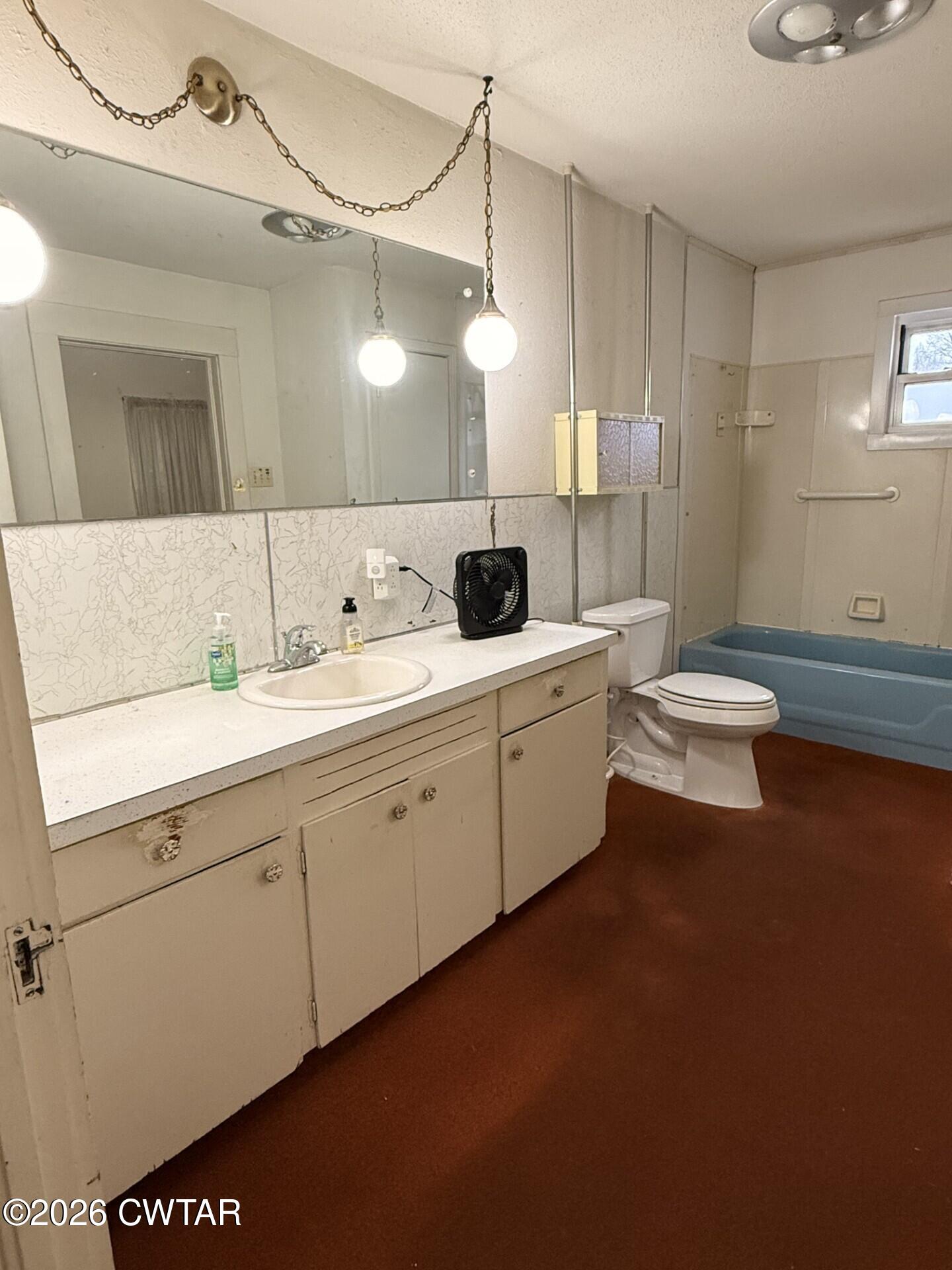 406 Maple Heights Street Kenton, TN 38233 - Photo 25 of 43 a bathroom with a sink a toilet and mirror