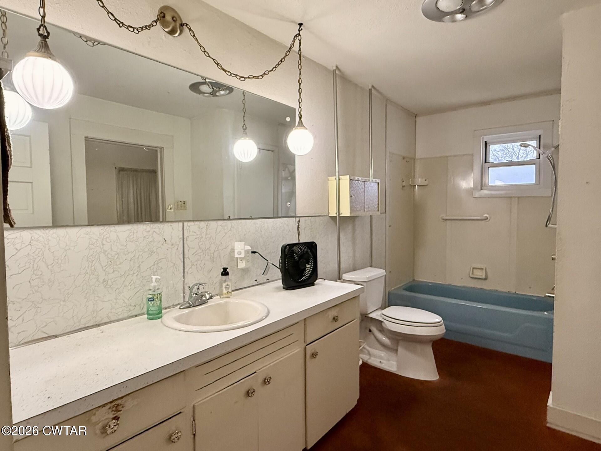 406 Maple Heights Street Kenton, TN 38233 - Photo 26 of 43 a bathroom with a double vanity sink a toilet and a mirror