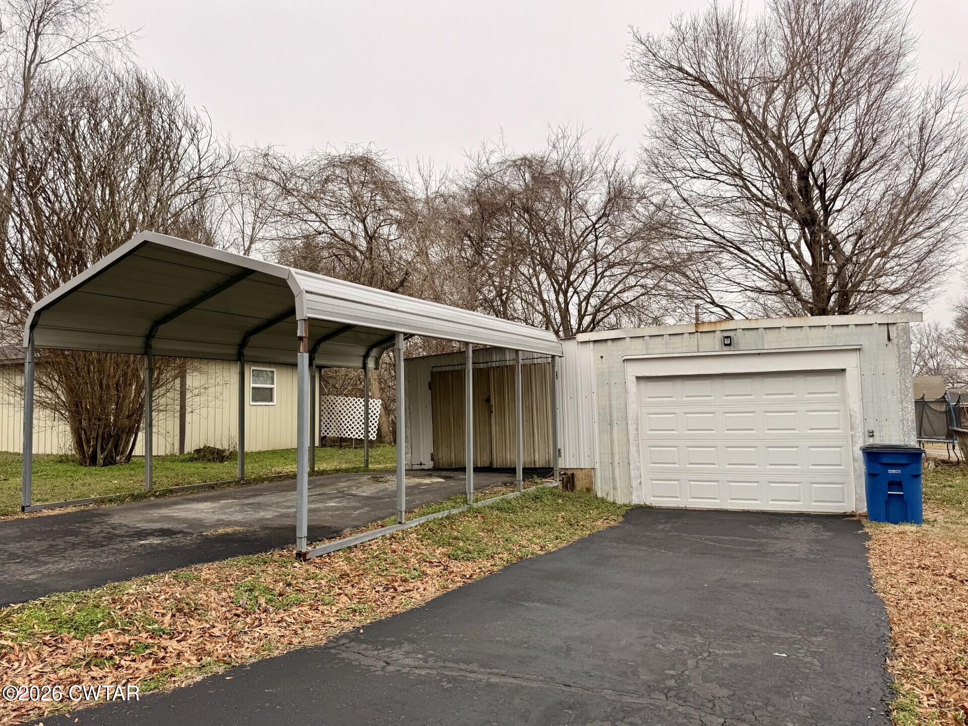 406 Maple Heights Street Kenton, TN 38233 - Photo 39 of 43 a view of a house with a yard and garage