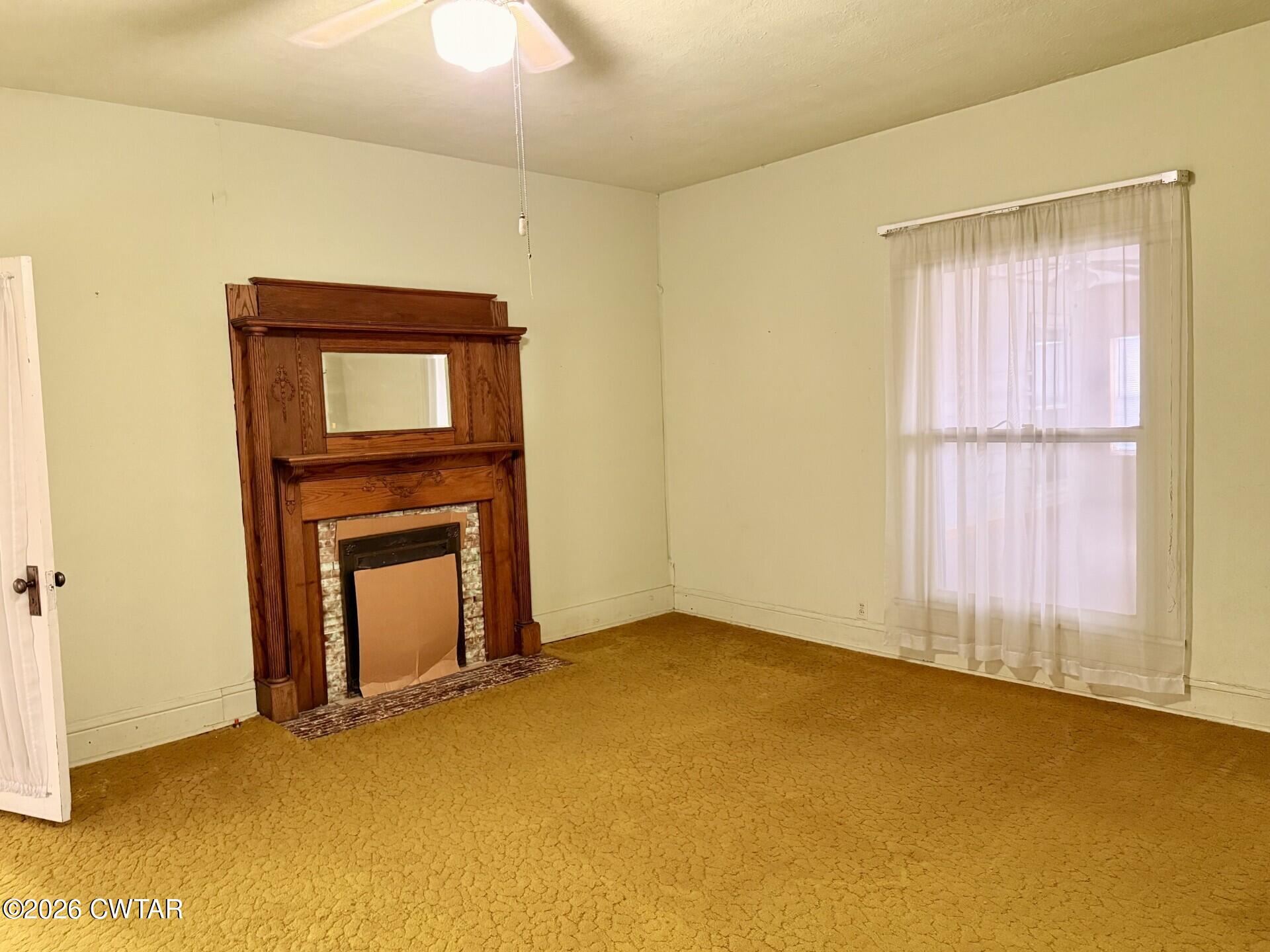 406 Maple Heights Street Kenton, TN 38233 - Photo 9 of 43 a view of an empty room with window and fire place