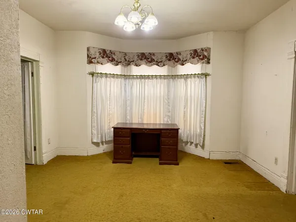 an empty room with a fireplace and painted walls