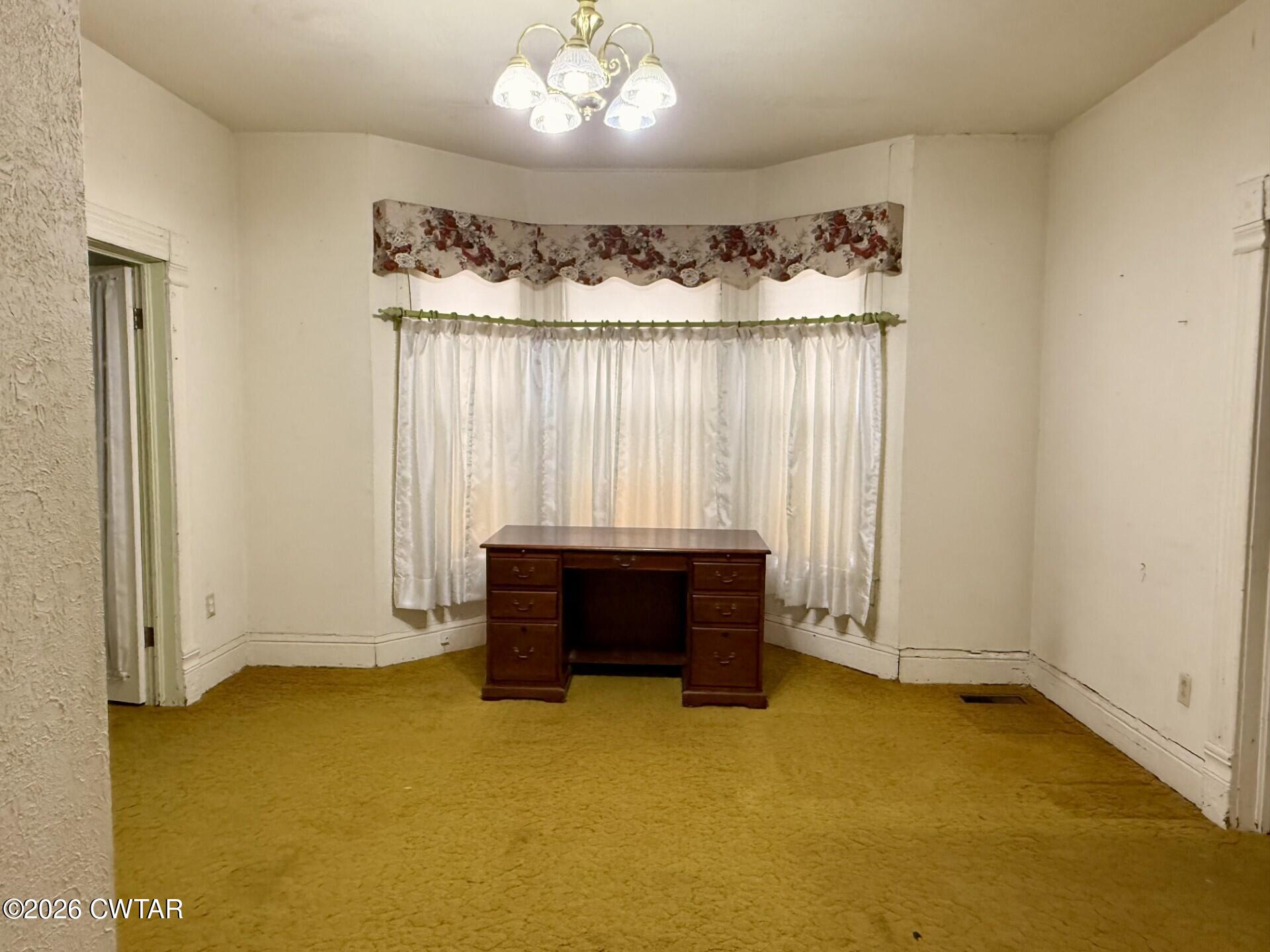 406 Maple Heights Street Kenton, TN 38233 - Photo 10 of 43 an empty room with a fireplace and painted walls