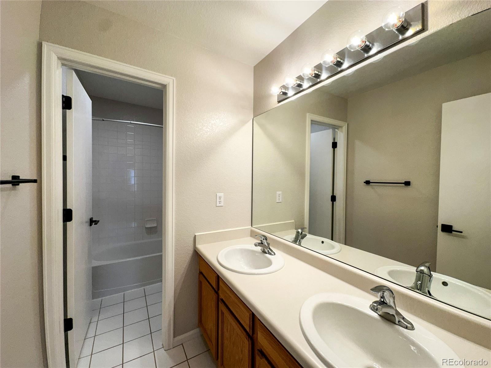 9933 Harris Street Denver, CO 80229 - Photo 20 of 25 a bathroom with a sink double vanity and a mirror