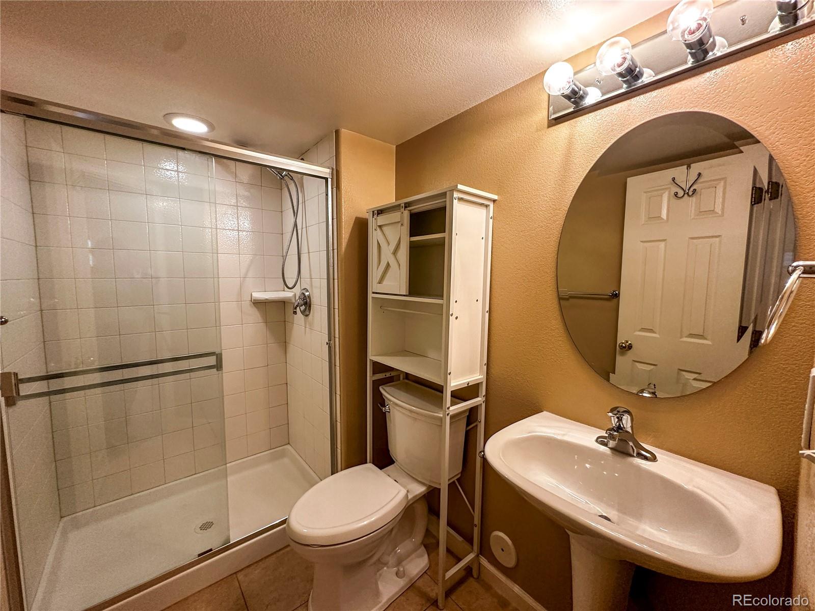 9933 Harris Street Denver, CO 80229 - Photo 22 of 25 a bathroom with a sink toilet and a mirror