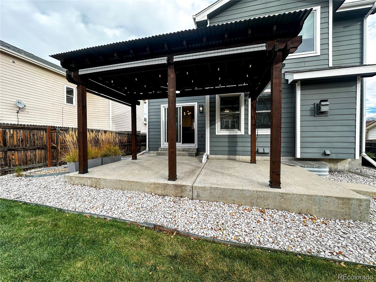 9933 Harris Street Denver, CO 80229 - Photo 23 of 25 a view of a porch with a table and chairs