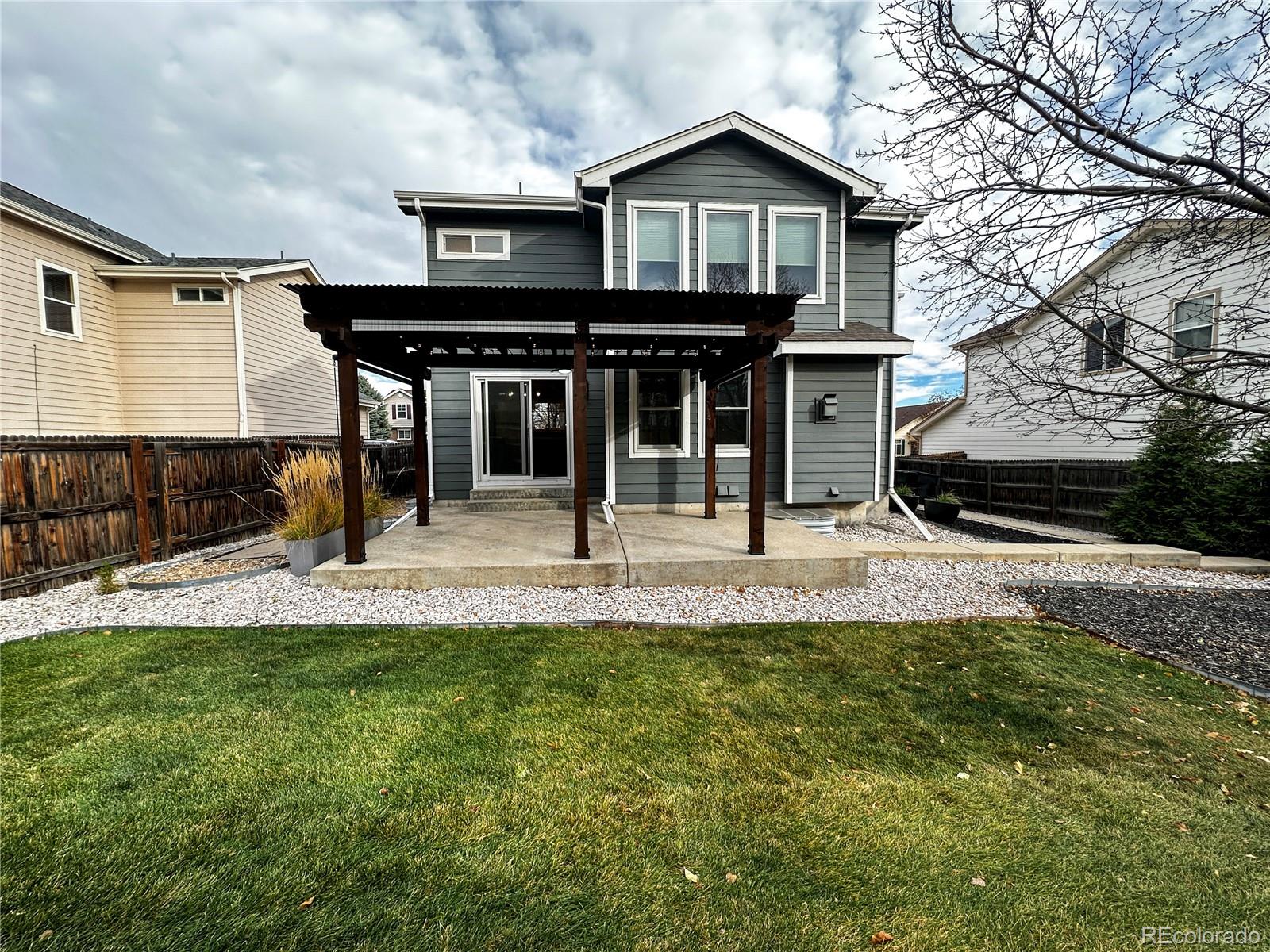 9933 Harris Street Denver, CO 80229 - Photo 25 of 25 a view of a house with a small yard and wooden fence