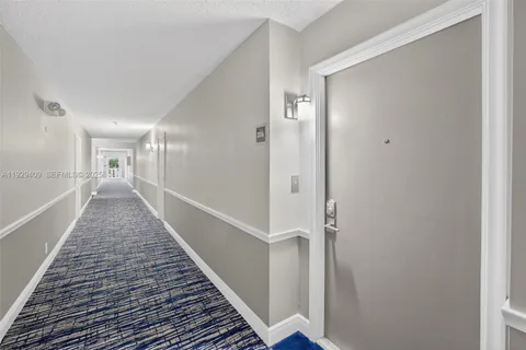 a large kitchen with stainless steel appliances granite countertop a stove a sink a dining table and chairs with wooden floor