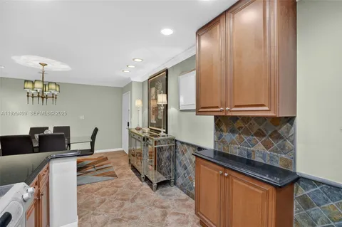 a bathroom with a granite countertop sink a toilet a mirror and shower