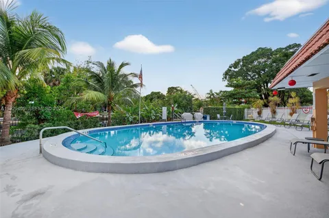a view of a dining room with furniture wooden floor and chandelier