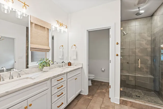 a bathroom with a double vanity sink mirror and double