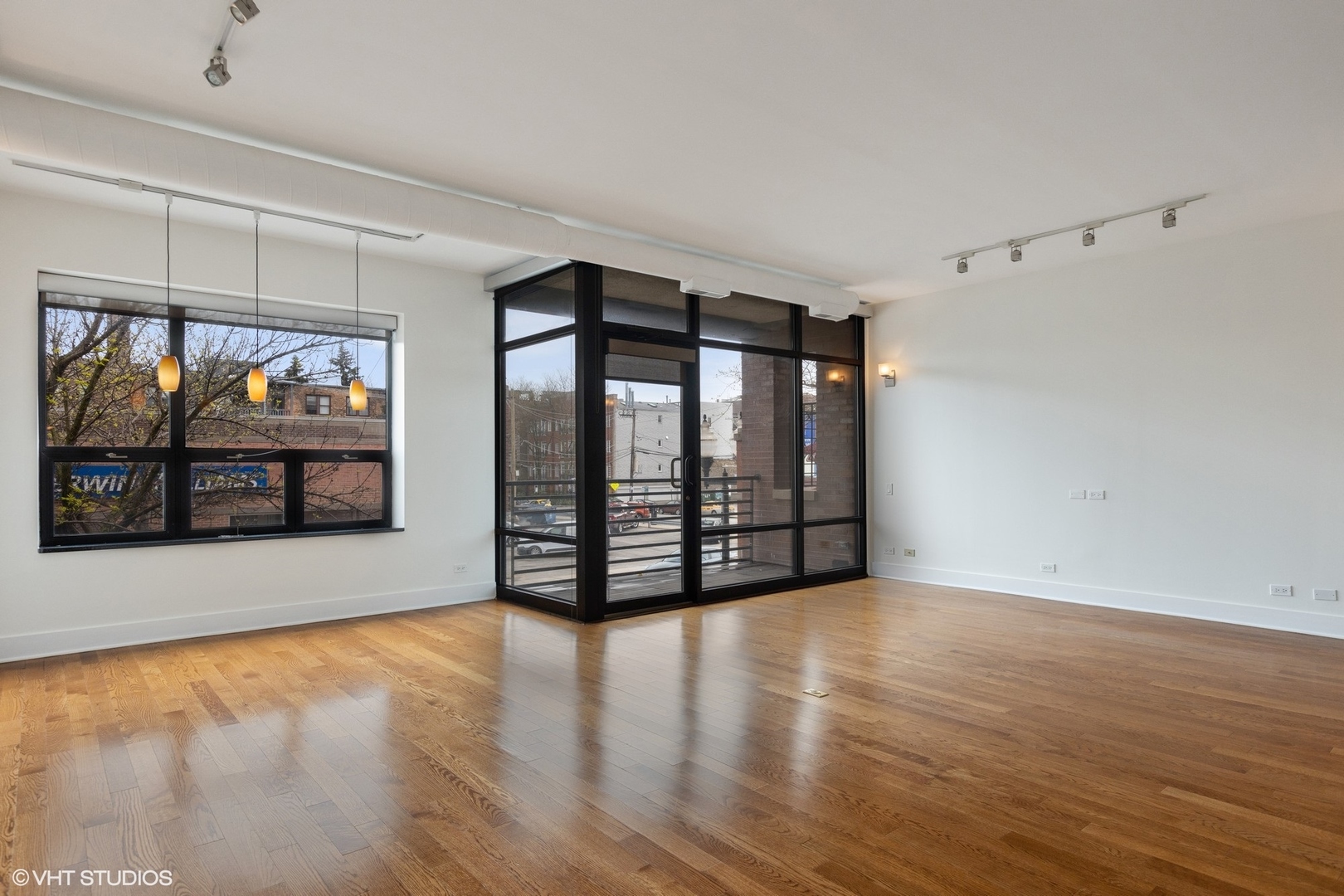 3310 North Halsted Street, Unit 2 Chicago, IL 60657 - Photo 3 of 22 a view of empty room with wooden floor and fan