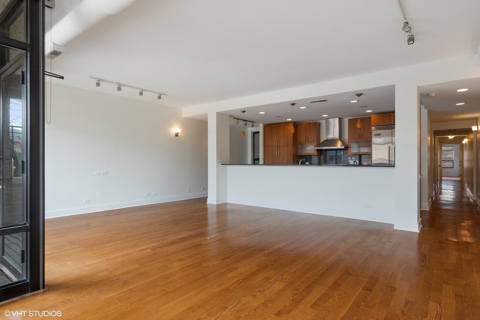 3310 North Halsted Street, Unit 2 Chicago, IL 60657 - Photo 4 of 22 a view of a kitchen with wooden floor and a kitchen