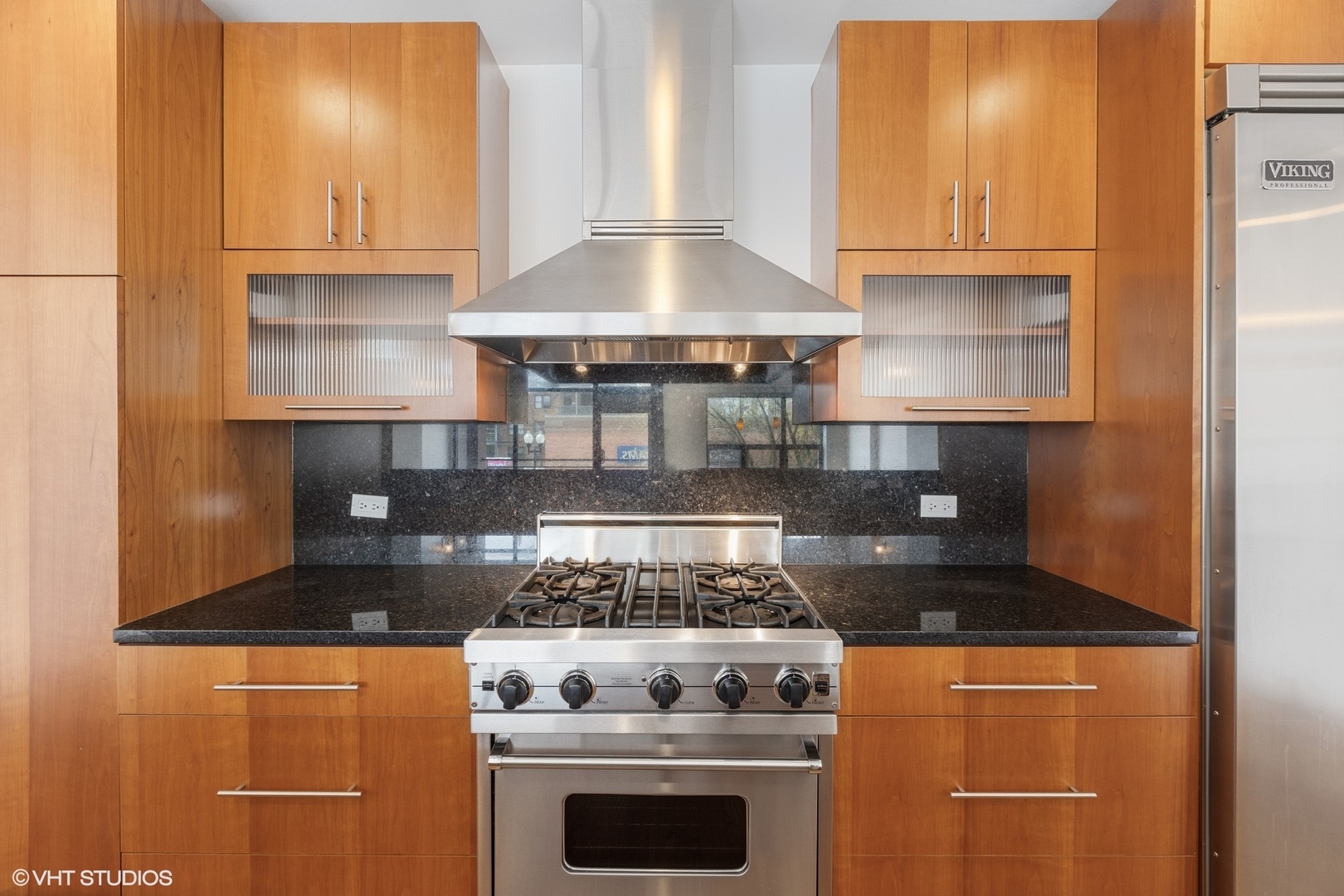 3310 North Halsted Street, Unit 2 Chicago, IL 60657 - Photo 6 of 22 a kitchen with granite countertop a stove and a cabinets