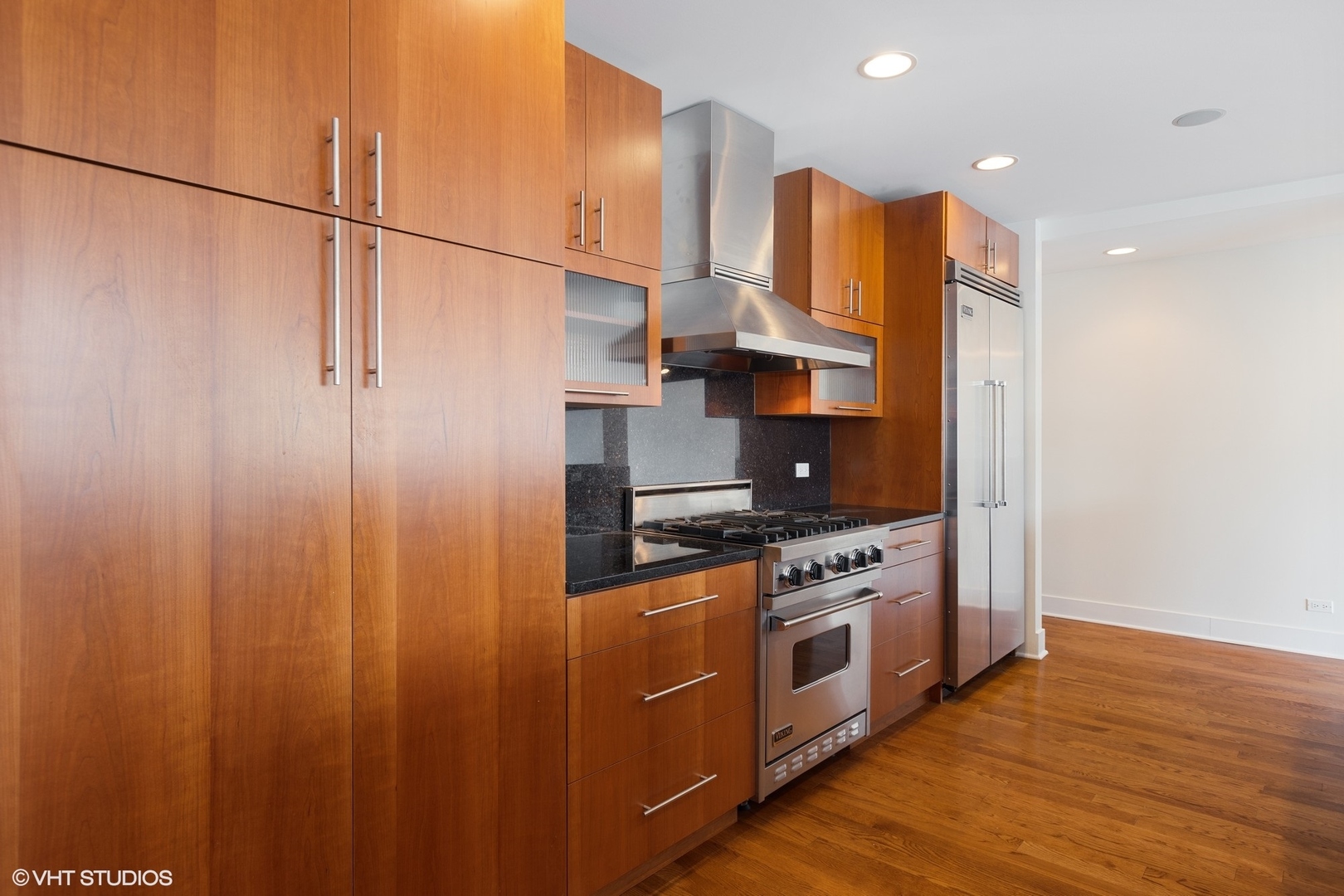 3310 North Halsted Street, Unit 2 Chicago, IL 60657 - Photo 7 of 22 a kitchen with stainless steel appliances granite countertop a stove a sink and a refrigerator