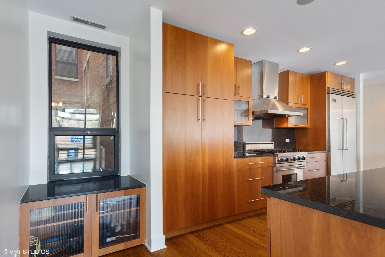 3310 North Halsted Street, Unit 2 Chicago, IL 60657 - Photo 8 of 22 a kitchen with stainless steel appliances granite countertop a refrigerator a stove and a sink