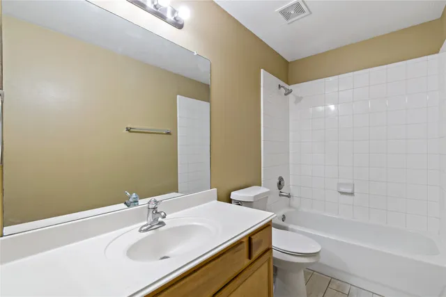 a bathroom with a sink mirror toilet and bathtub