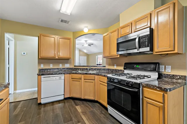 a kitchen with stainless steel appliances granite countertop a stove and a microwave