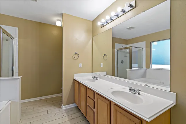 a spacious bathroom with a sink double vanity and a mirror