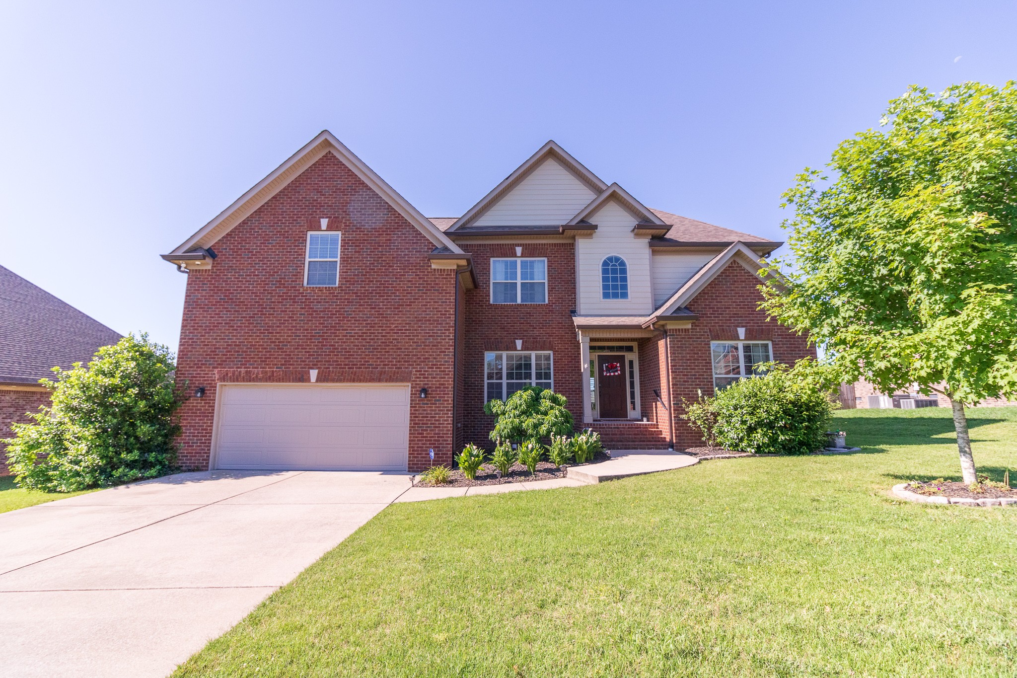 a front view of a house with a yard and garage
