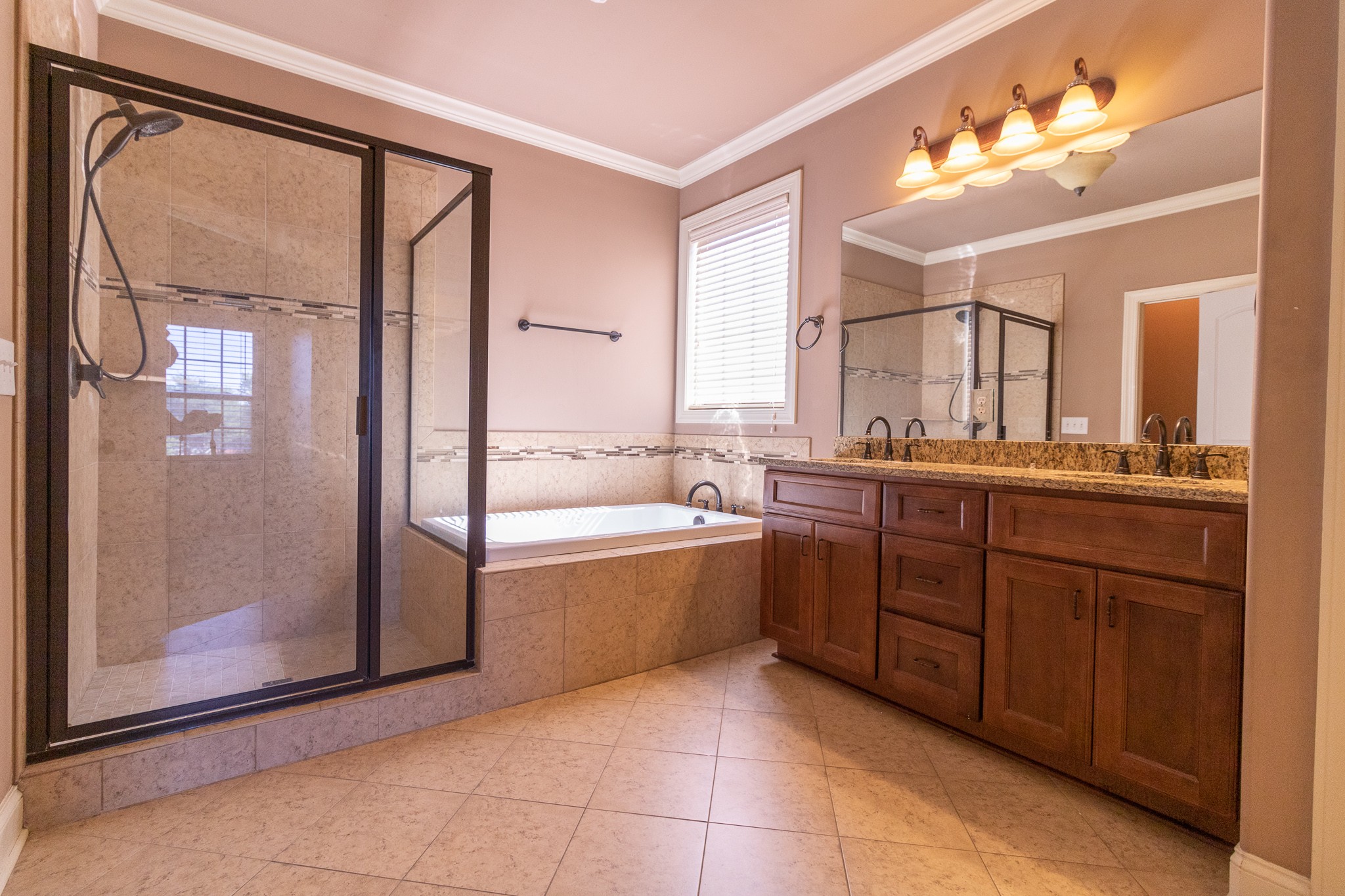 3075 Sakari Circle Spring Hill, TN 37174 - Photo 12 of 35 a spacious bathroom with a vanity a sink a mirror and a bathtub