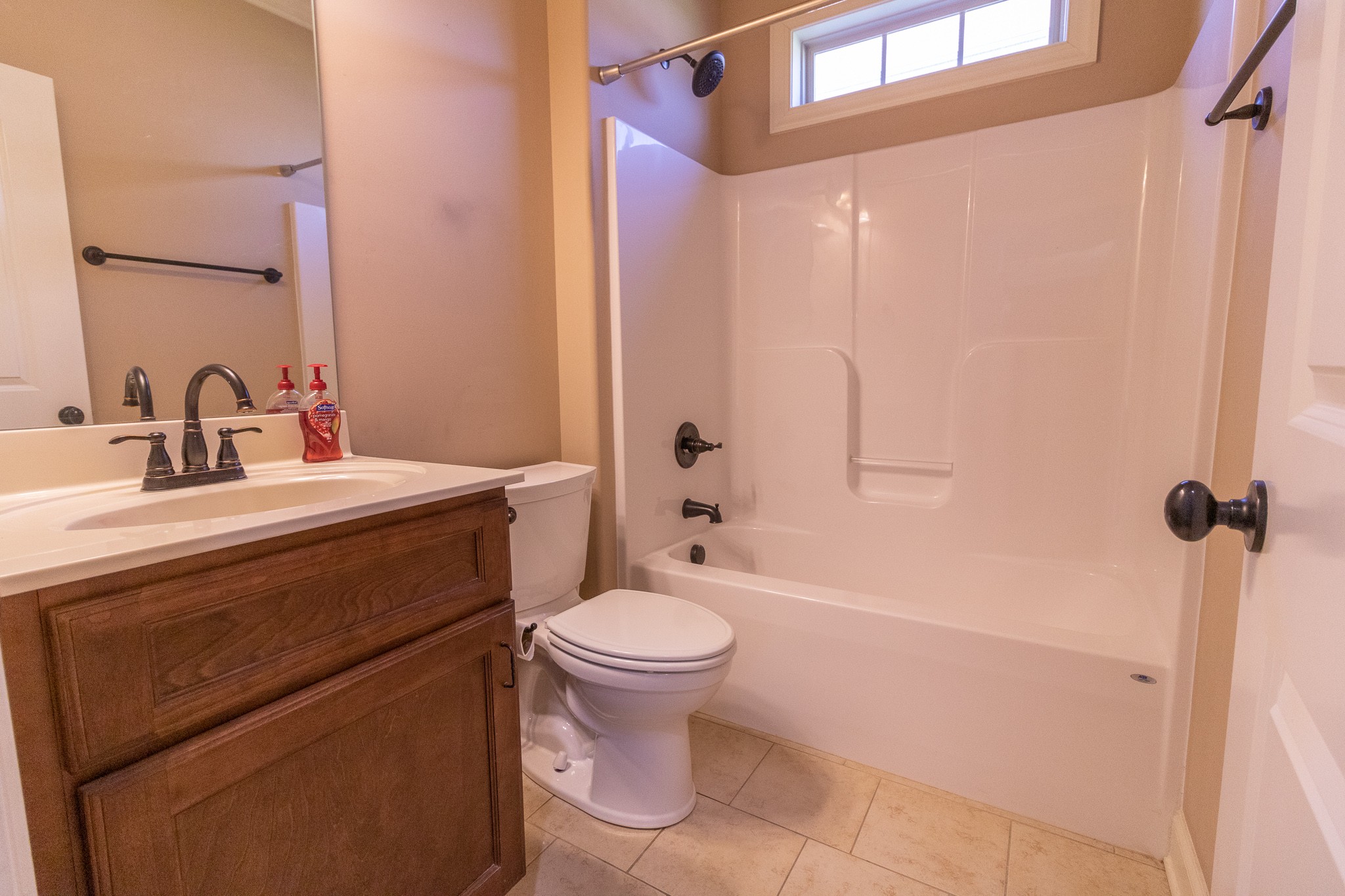 3075 Sakari Circle Spring Hill, TN 37174 - Photo 18 of 35 a bathroom with a granite countertop sink toilet mirror and shower