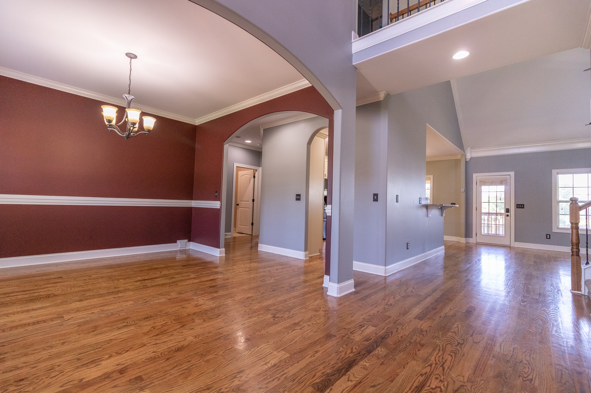 3075 Sakari Circle Spring Hill, TN 37174 - Photo 2 of 35 a view of a hallway with wooden floor and chandelier