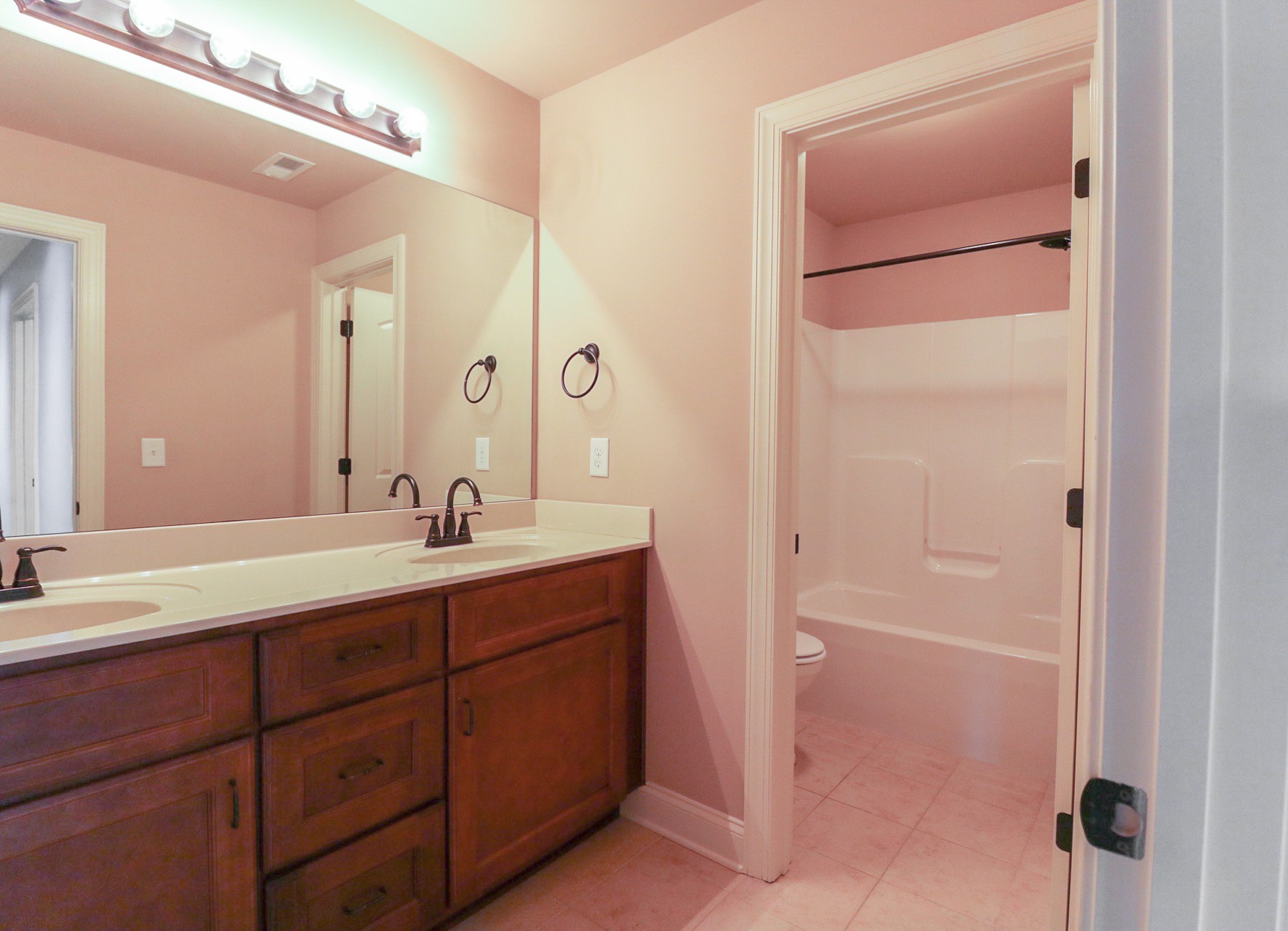 3075 Sakari Circle Spring Hill, TN 37174 - Photo 29 of 35 a bathroom with a double vanity sink and a mirror