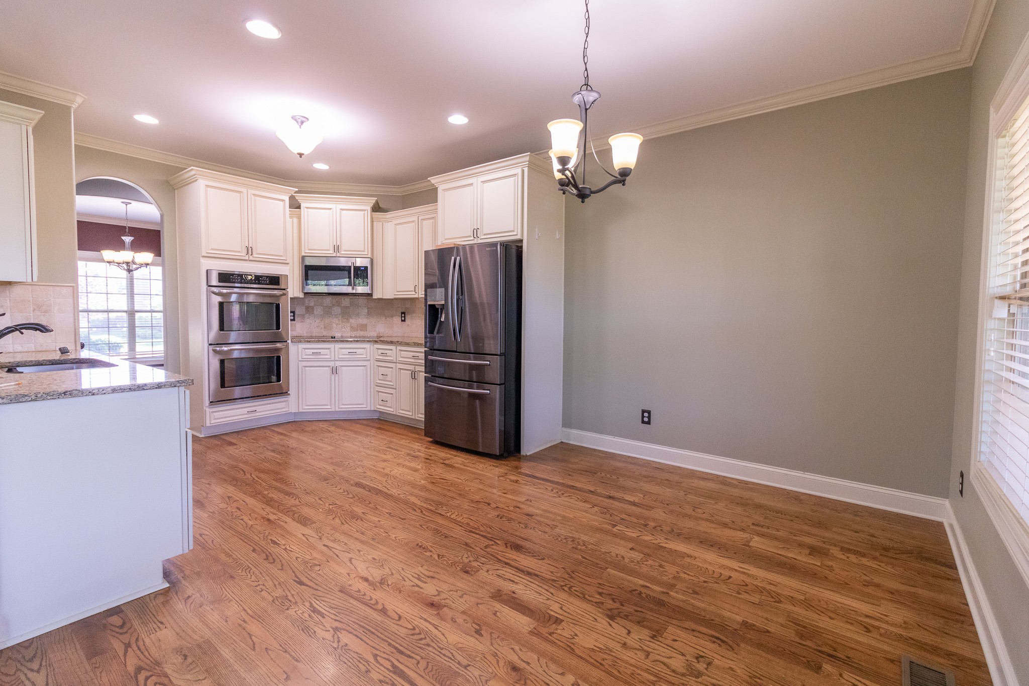 3075 Sakari Circle Spring Hill, TN 37174 - Photo 8 of 35 a view of kitchen with refrigerator microwave and wooden floor