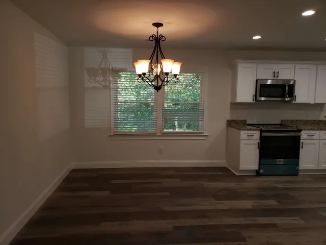a kitchen with a stove and a window