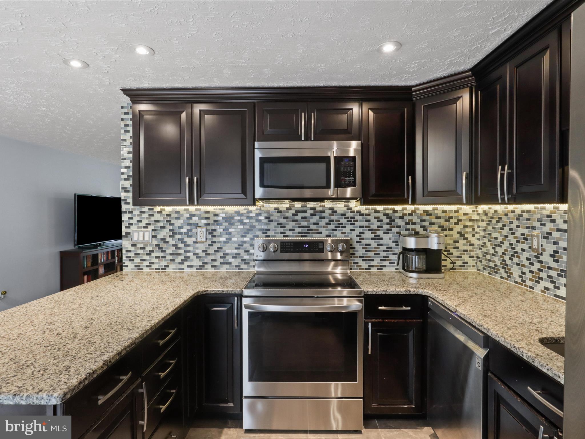 7313 Husky Lane Springfield, VA 22151 - Photo 15 of 49 a kitchen with a sink stove and microwave