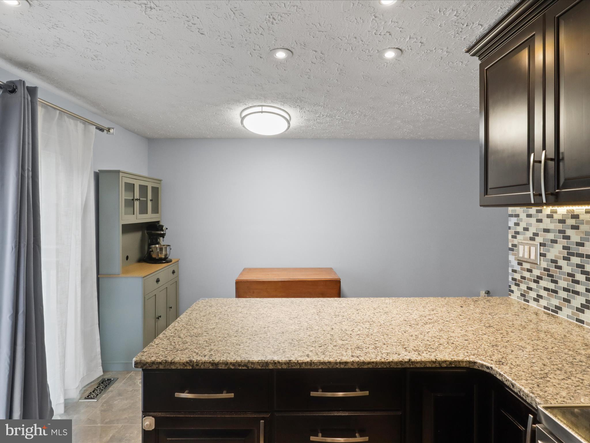 7313 Husky Lane Springfield, VA 22151 - Photo 16 of 49 a kitchen with granite countertop stainless steel appliances and wooden cabinets