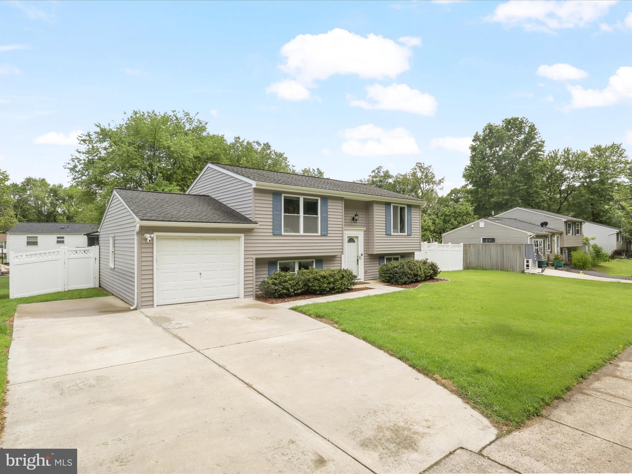 7313 Husky Lane Springfield, VA 22151 - Photo 2 of 49 a front view of a house with a yard and garage