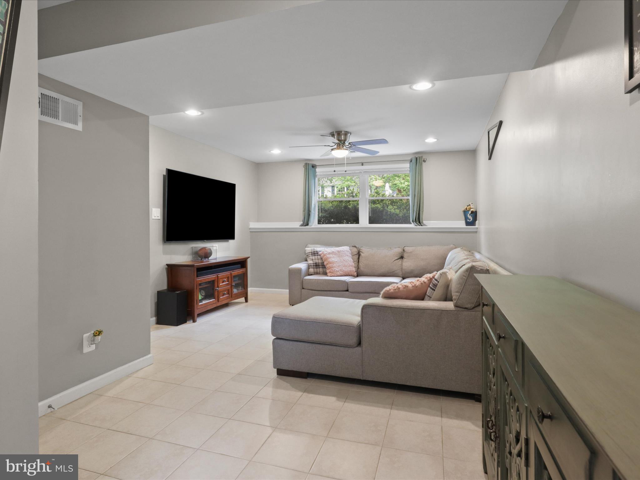 7313 Husky Lane Springfield, VA 22151 - Photo 25 of 49 a living room with furniture and a flat screen tv