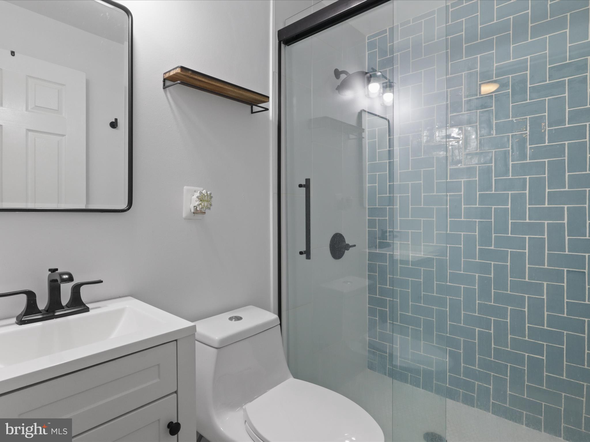 7313 Husky Lane Springfield, VA 22151 - Photo 27 of 49 a bathroom with a toilet a sink and shower