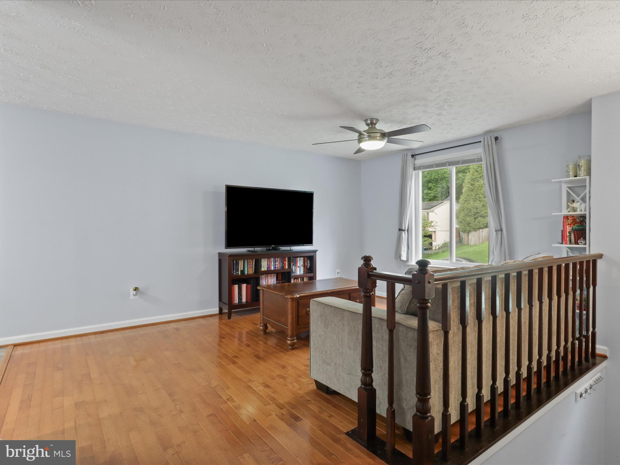 7313 Husky Lane Springfield, VA 22151 - Photo 5 of 49 a living room with furniture and a flat screen tv