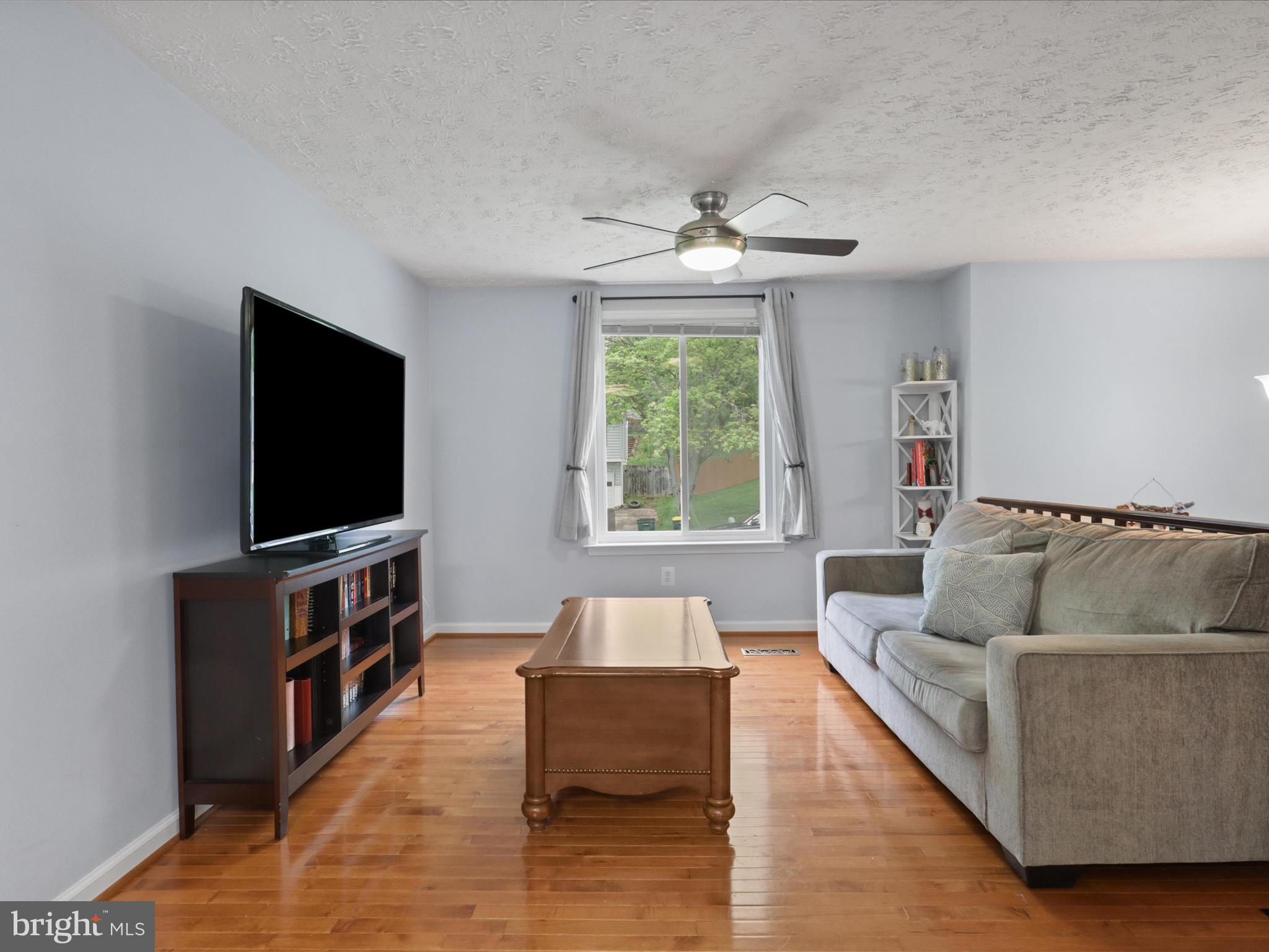 7313 Husky Lane Springfield, VA 22151 - Photo 7 of 49 a living room with furniture and a flat screen tv