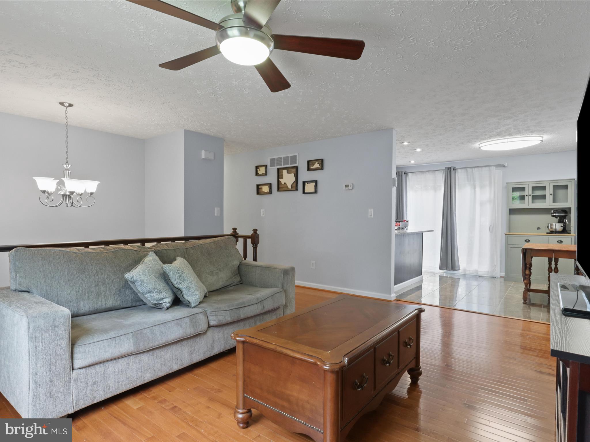 7313 Husky Lane Springfield, VA 22151 - Photo 8 of 49 a living room with furniture and a chandelier