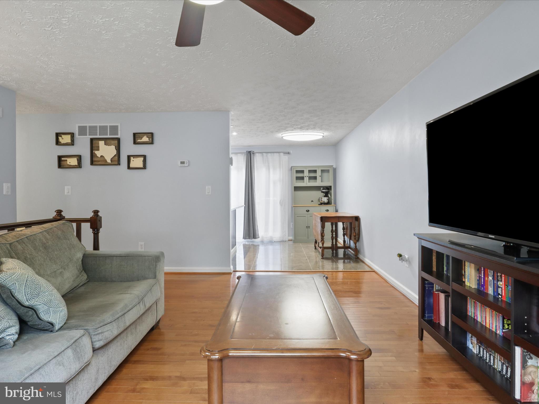 7313 Husky Lane Springfield, VA 22151 - Photo 9 of 49 a living room with furniture and a flat screen tv
