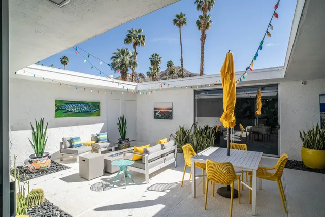 a living room with patio furniture and a flat screen tv