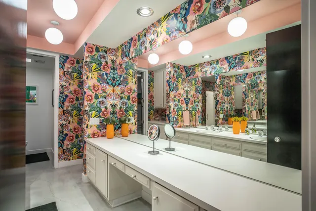 a bathroom with a sink and a chair