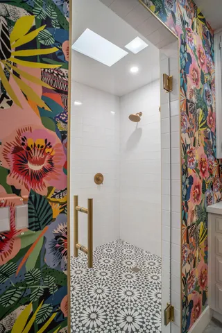 a living room with furniture and a painting on the wall