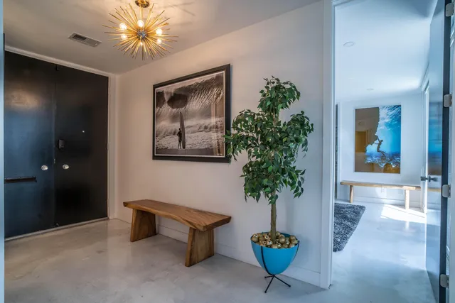 a living room with furniture and large windows